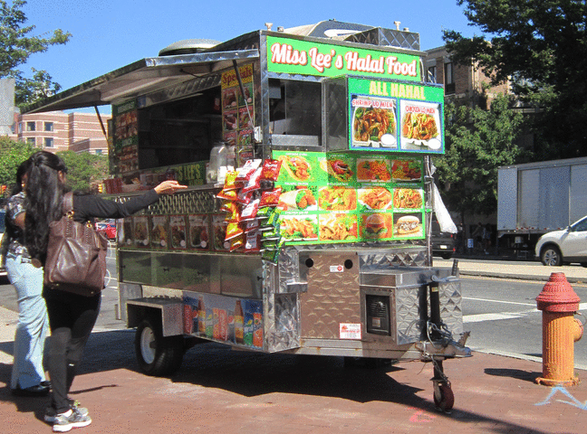 Two people ordering from a halal food cart halal-cart.gif